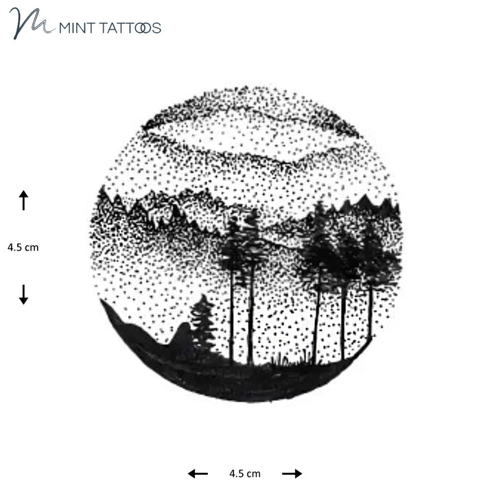 Temporary tattoo from Mint Tattoos. Dot style nature landscape with tall trees and mountains