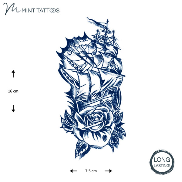 Long lasting temporary tattoo. Ink blue ship with many sails and a rose with leaves underneath