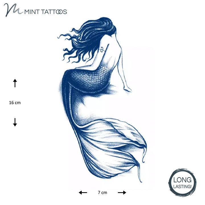 Ink Blue, long lasting temporary tattoo from Mint Tattoos.  Back view of sitting mermaid with long hair