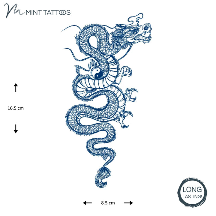 Long lasting temporary tattoo from Mint Tattoos.  Ink blue dragon has a snake like winding body.  Claws are holding a small yin and yang symbol