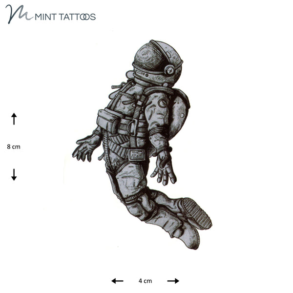 Temporary tattoo from Mint Tattoos. Hand drawn grey shaded astronaut floating in space