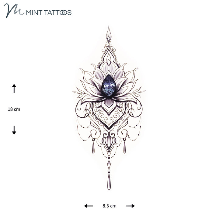 Temporary tattoo from Mint Tattoos. Centre is a navy faceted pear jewel surrounded by an abstract ornamental design. Measures 8 x 18 cm