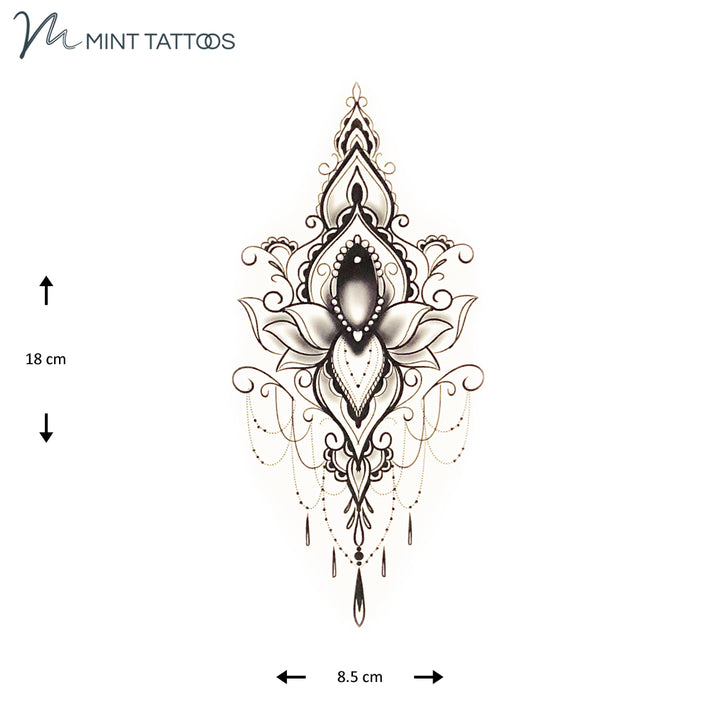 Temporary tattoo from Mint Tattoos. Centre is an oval cabochon jewel surrounded by a scroll ornamental design. Measures 8 x 18 cm