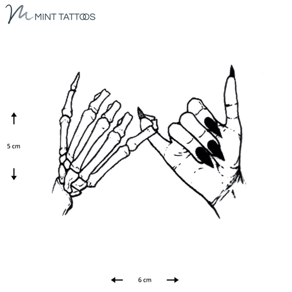 Temporary tattoo from Mint Tattoos.  One skeletal hand and one female hand with long nails, both with their pinky fingers together