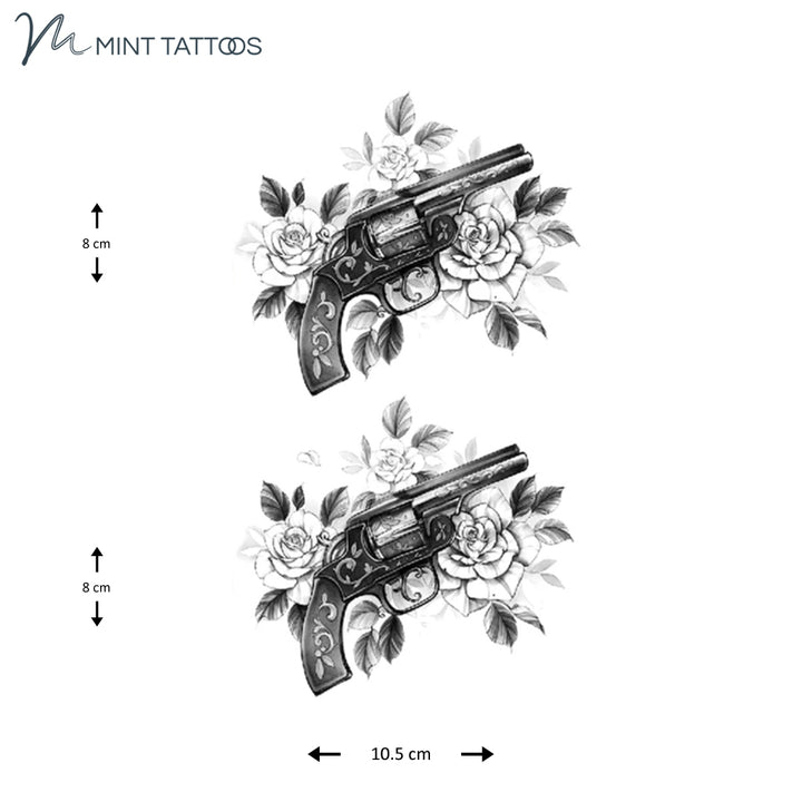 Temporary tattoo from Mint Tattoos. Side profile of a hand gun with a scroll pattern, in a bed of roses. 2 quantity, each measures 8 x 10 cm