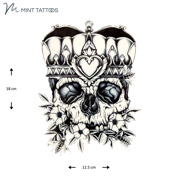 Temporary tattoo from Mint Tattoos.  Bold black design of skull eyes and nose wearing a crown with flowers in the mouth area. Measures 12 x 18 cm